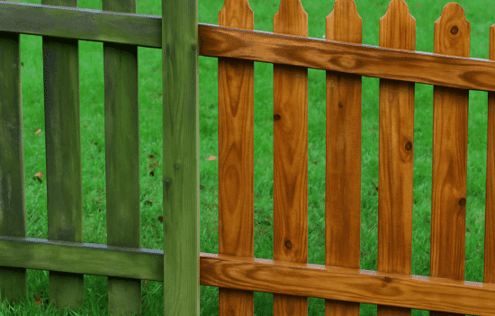 Mildewed wood fence before and after pressure washing