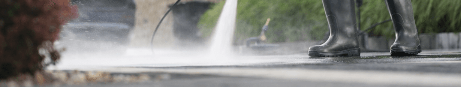 Man Pressure Washing Driveway Wide Angle V5