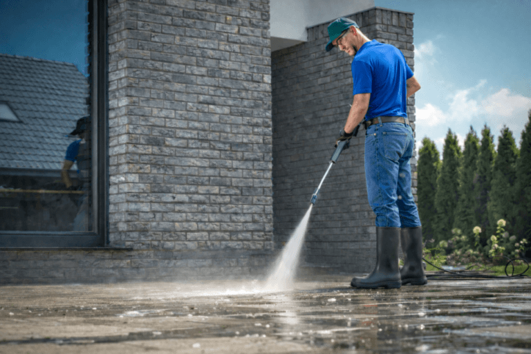Man Pressure Washing Stone Patio